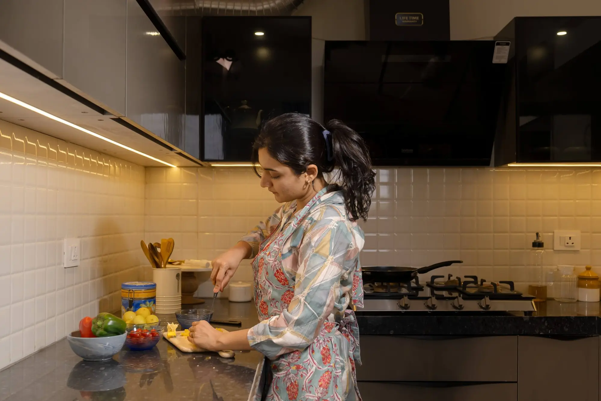 A woman cooking in a modular kitchen