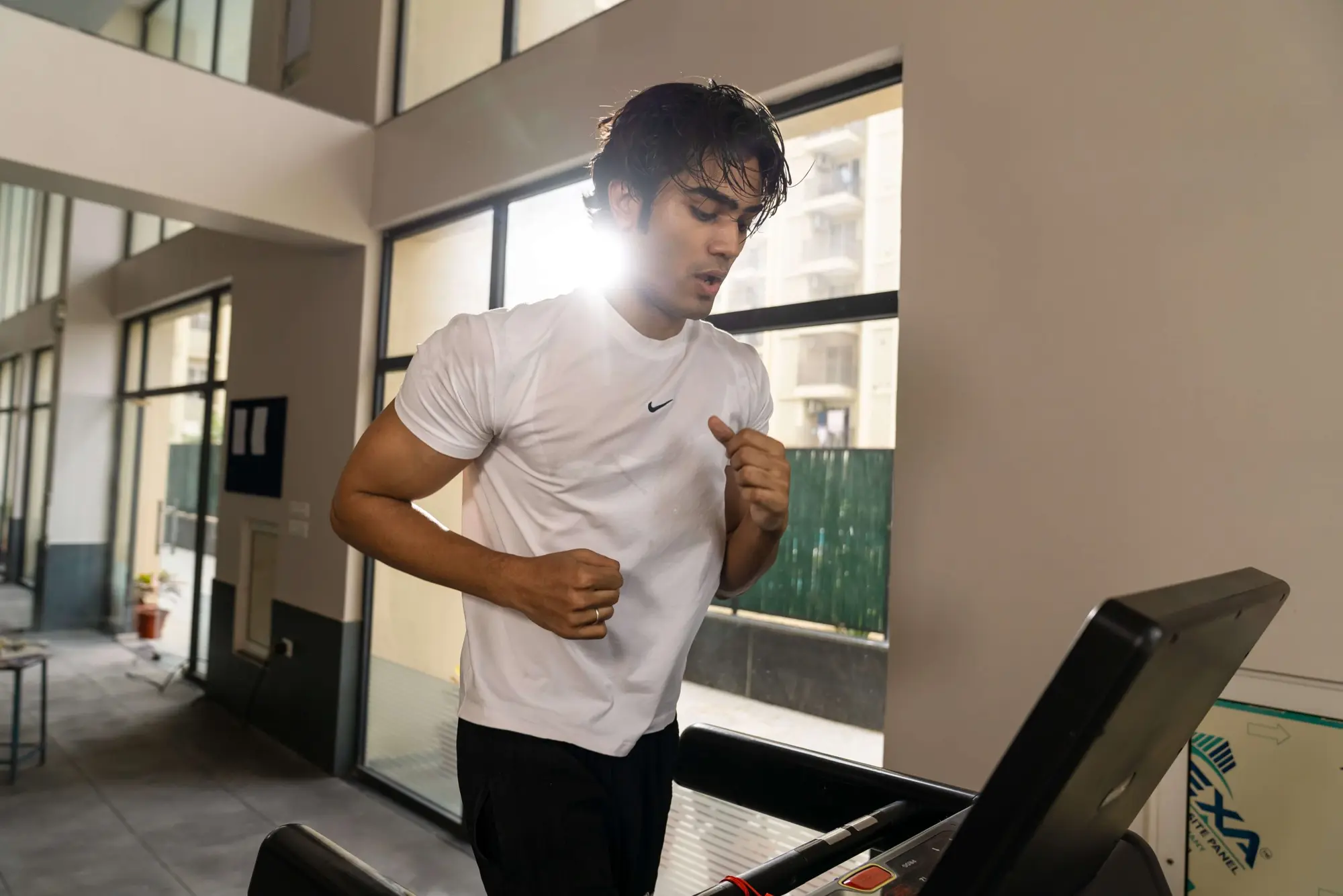 A resident running on a treadmill in the gym